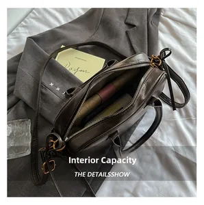 Detail view of the spacious interior compartment with a zipper pocket in a brown leather bag