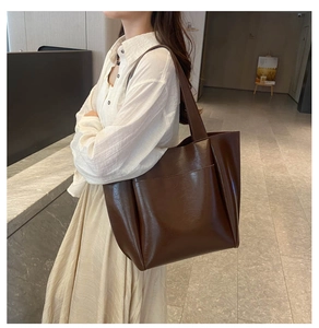 Side view of dark brown glossy tote bag showing large capacity for daily commuting