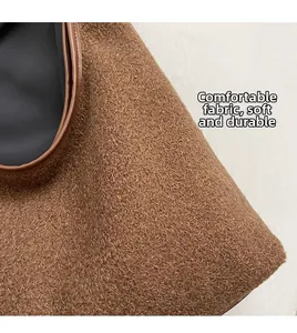 Detail of brown faux shearling fabric with smooth leather trim and soft texture