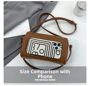 Brown lychee leather cylinder crossbody bag shown next to a smartphone for size reference