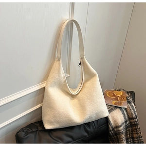 Detail of minimalist beige felt hobo bag showing thick autumn texture and zipper closure