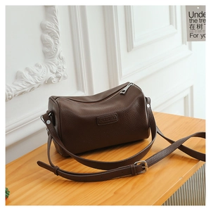 Close-up of dark brown lychee leather Boston bag featuring top zipper and brand debossing