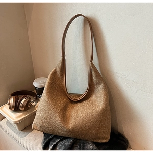 Detailed texture of brown wool hobo bag with leather strap and lifestyle accessories