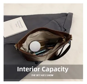 Detailed internal view of large brown tote showing spacious capacity for daily essentials