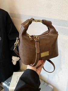 Vintage dark brown faux leather handbag with knot handle and gold buckle detail