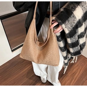 Brown textured wool tote bag shown on a model for autumn winter commute style