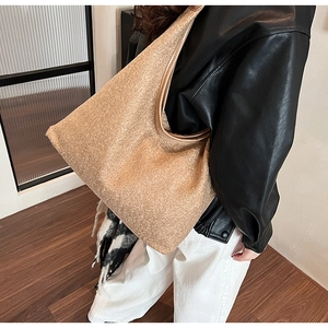 Close-up of tan wool tote bag showing thick texture and wide shoulder strap