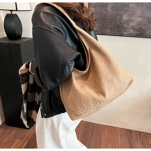 Detailed close-up of a camel wool tote bag with soft texture and leather shoulder strap