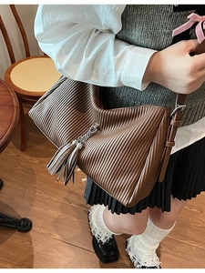 Retro deep brown pleated leather hobo bag with fringe detail and adjustable shoulder strap