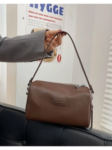 Brown lychee leather pillow bag with silver zipper and logo for women fashion
