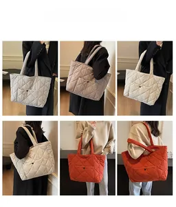 Quilted puffer tote bag with large front pockets and padded straps shown on model