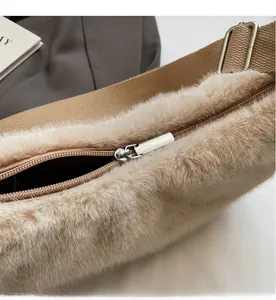 Close-up of smooth metal zipper and soft faux fur texture on the beige shoulder bag