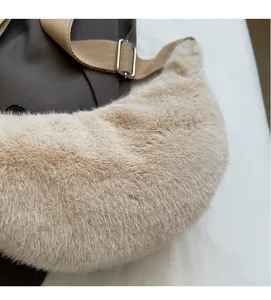Close-up of soft beige plush crescent bag showing fuzzy texture and canvas strap