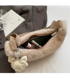Spacious interior of beige plush shoulder bag showing brown zipper and daily essentials
