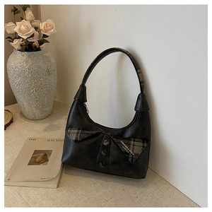 Detailed view of women's underarm bag with suit collar design and grey plaid patterns