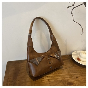 Detailed view of the vintage brown shoulder bag with plaid collar design and textures