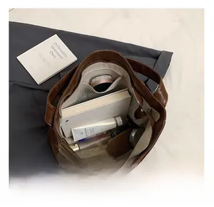 Top view of brown leather tote bag interior showing large capacity and zipper pocket