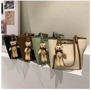 Detailed close-up of premium tote bags in four colors with cute bear charms
