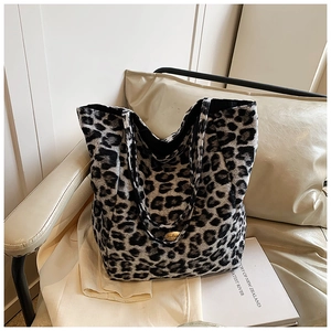 Detail of leopard print bucket bag with golden logo plaque and soft plush texture