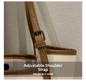 Detailed view of adjustable brown leather shoulder strap with silver buckle on a tote bag