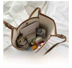 Interior view of tote bag showing large capacity with daily essentials and magnetic clasp