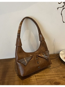 Vintage brown shoulder bag featuring plaid fabric patchwork and retro buttons