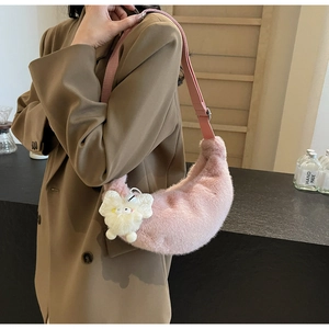 Detail view of pink plush crescent moon shoulder bag with soft texture and cartoon charm