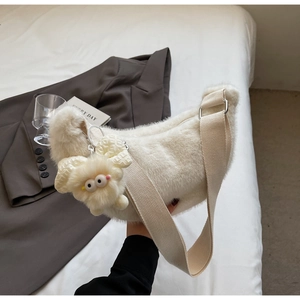 Detail of white plush half-moon shoulder bag with cute lamb charm and wide strap