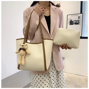 Contrast tote bag set in cream and brown with a cute bear charm shown on a model