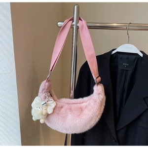 Pink faux fur crescent crossbody bag with wide strap and cute white bunny pendant