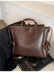 Vintage dark brown leather backpack with contrast stitching and large capacity storage