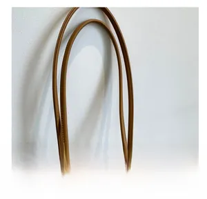 Detail of cream tote bag with sturdy brown handles and smooth metal zipper closure