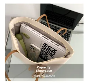 Large capacity tote bag showing interior space for laptop, books, and daily essentials