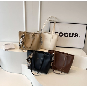 Detail shot of four premium tote bags in neutral colors with decorative scarves