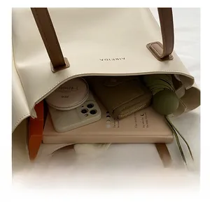 Top view of large cream leather tote bag interior showing daily storage capacity