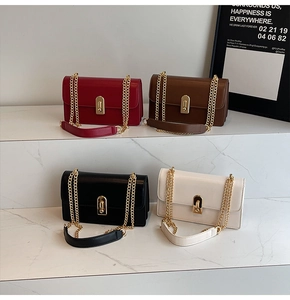 Four colors of minimalist crossbody bags displayed on marble steps with gold hardware