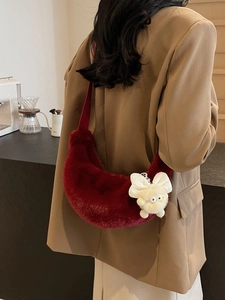 Fashionable wine red plush crescent shoulder bag with a cute monster doll charm