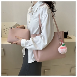 Detailed set of pink tote bag and small zipper pouch with a cute cartoon pendant charm