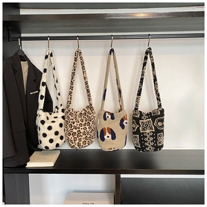 Detail view of plush shoulder bags in leopard print, polka dot, and geometric patterns