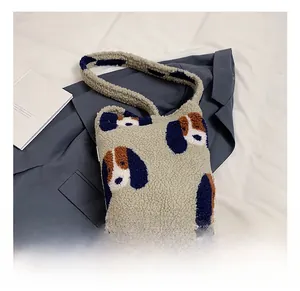 Close-up of plush cream tote bag featuring cute cartoon dog patterns and soft texture