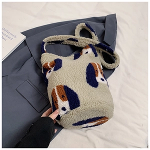 Detail of soft plush bucket bag featuring navy dog pattern and cozy lamb wool texture