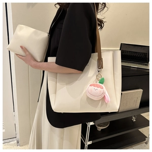 Chic cream tote bag and pouch set with brown strap and peach charm on shoulder
