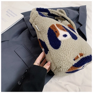 Macro detail of plush sherpa bucket bag featuring a stitched patchwork puppy design