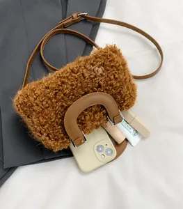 Detail view of the plush wool crossbody bag showing spacious interior for phone and lipstick