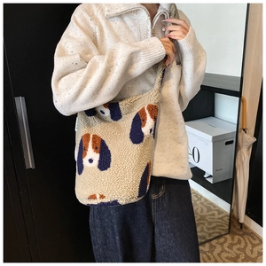 Close-up of the fuzzy teddy fabric texture and cartoon dog pattern on this bucket bag