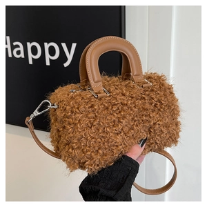 Close-up of brown wool crossbody bag with plush texture and leather handles