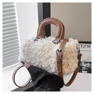 Close-up of white faux fur material and brown leather strap on a mini crossbody bag