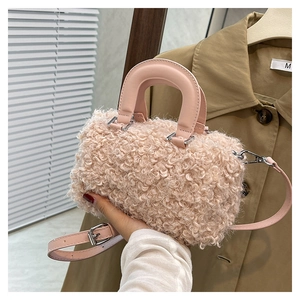 Detailed texture of pink plush crossbody box bag with smooth handle and strap