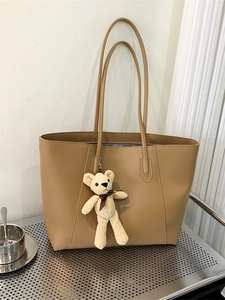 Minimalist camel faux leather tote bag with a cute knit teddy bear charm for women