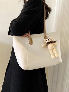 Minimalist large white tote bag with brown straps and cute knitted bear charm accessory